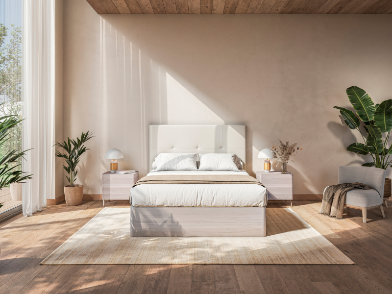 Dormitorio moderno con cama tapizada blanca, mesitas de noche y decoración natural en tonos claros, creando un ambiente acogedor y elegante para el descanso.